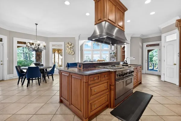 a spacious bedroom with a large bed and a chandelier