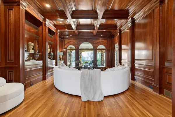 a spacious bedroom with a bed a couch and a chandelier