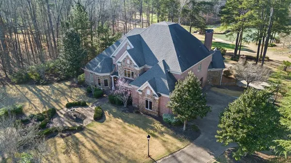 a view of a dining room with furniture a chandelier and wooden floor