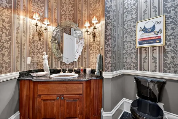 a spacious bedroom with a bed chandelier and a large window