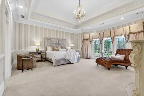 a large white kitchen with stainless steel appliances kitchen island granite countertop a sink and cabinets