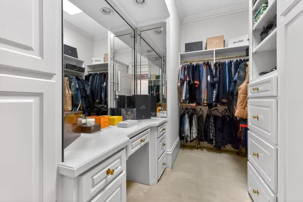 a spacious bedroom with a bed and a chandelier