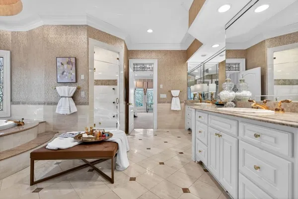 a spacious bedroom with a bed and a chandelier