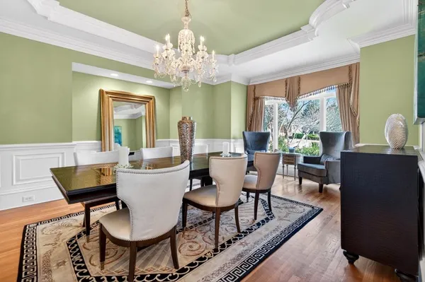 a living room with furniture a fireplace and a chandelier
