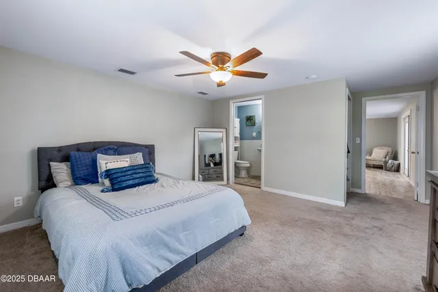 a bedroom with a bed and a ceiling fan