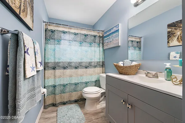 a bathroom with a sink a toilet and a shower