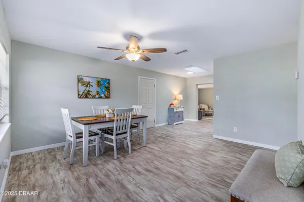 a view of a dining room with furniture and wooden floor