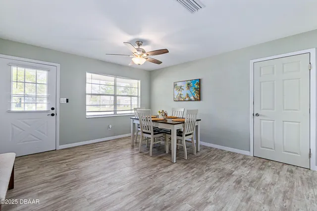 a dining room with wooden floor and a window