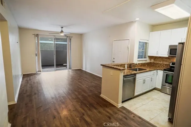 a kitchen with stainless steel appliances granite countertop a stove and a sink