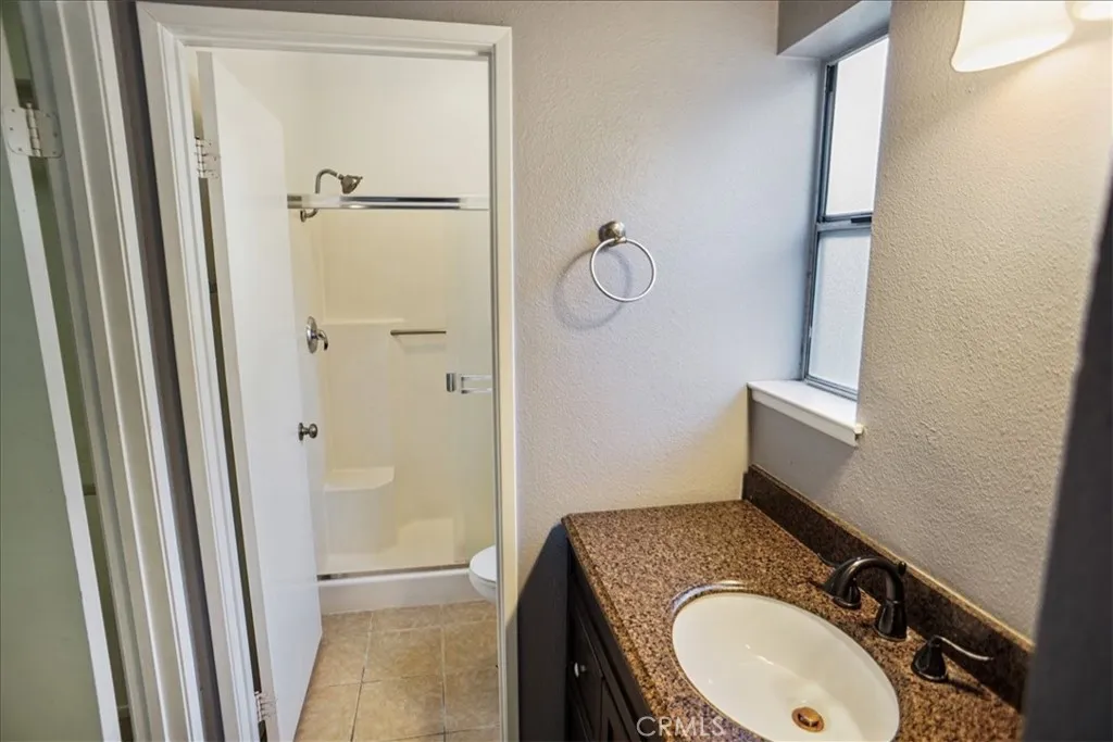 27646 Susan Beth Way Saugus, CA 91350 - Photo 10 of 12 a bathroom with a granite countertop sink toilet and shower