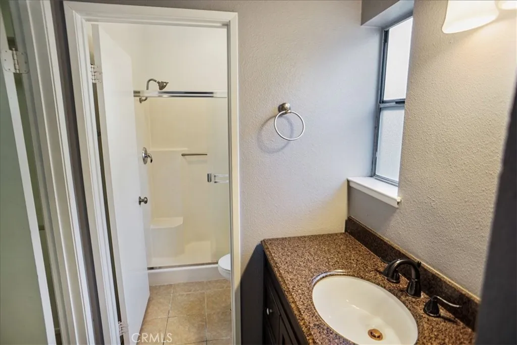 27646 Susan Beth Way Saugus, CA 91350 - Photo 10 of 12 a bathroom with a granite countertop sink toilet and shower
