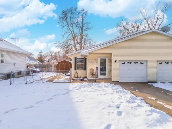 a view of a house with a snow in the yard