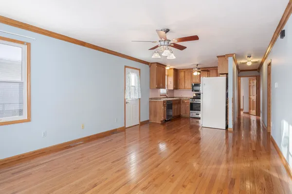 a view of kitchen with wooden floor electronic appliances and window