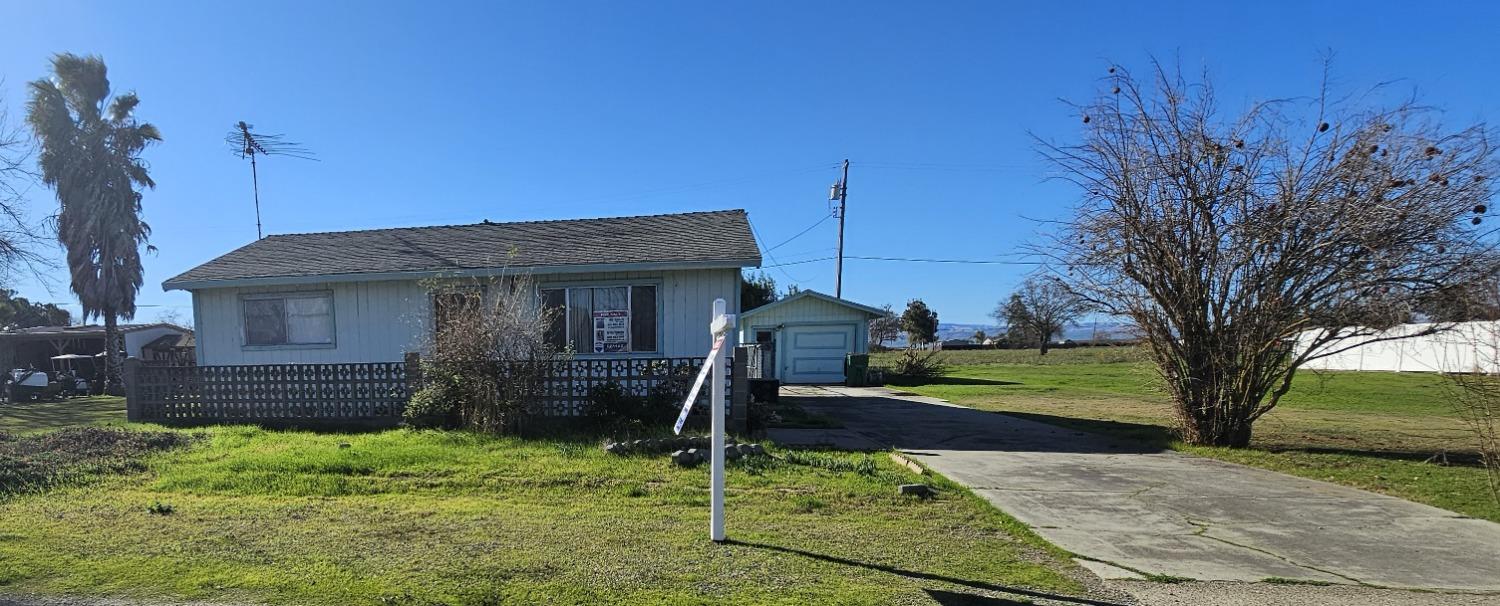 30000 Kasson Road Tracy, CA 95304 - Photo 1 of 1 a front view of a house with garden