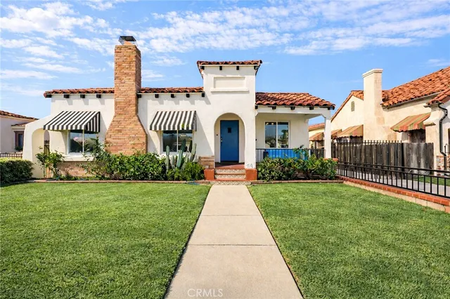 a front view of a house with a garden