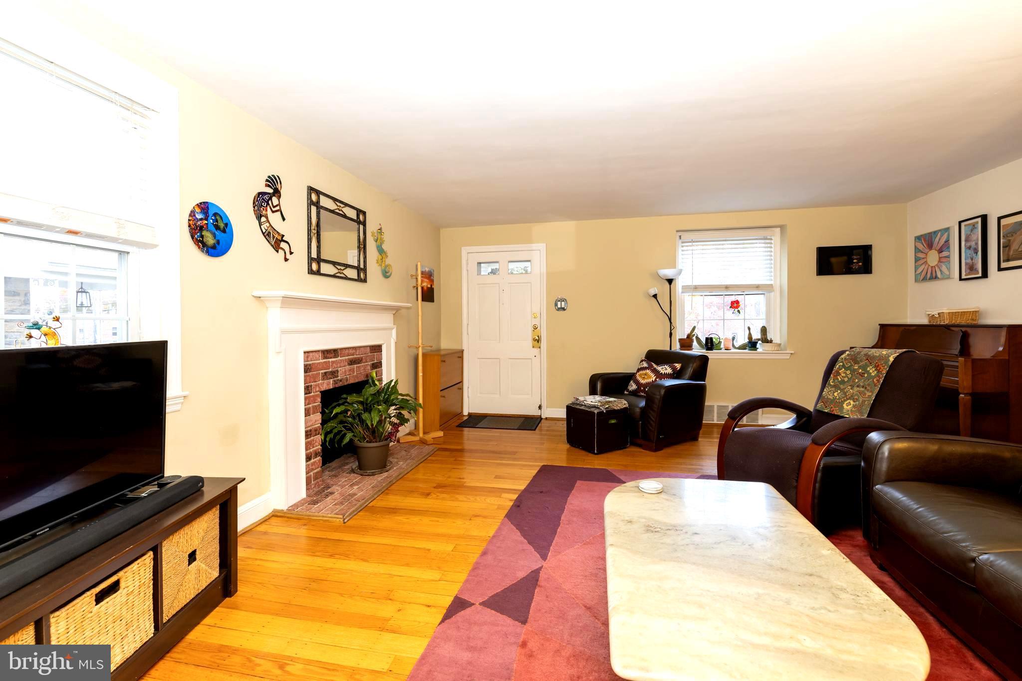 52 Woodbine Road Havertown, PA 19083 - Photo 11 of 38 a living room with furniture a flat screen tv and a fireplace