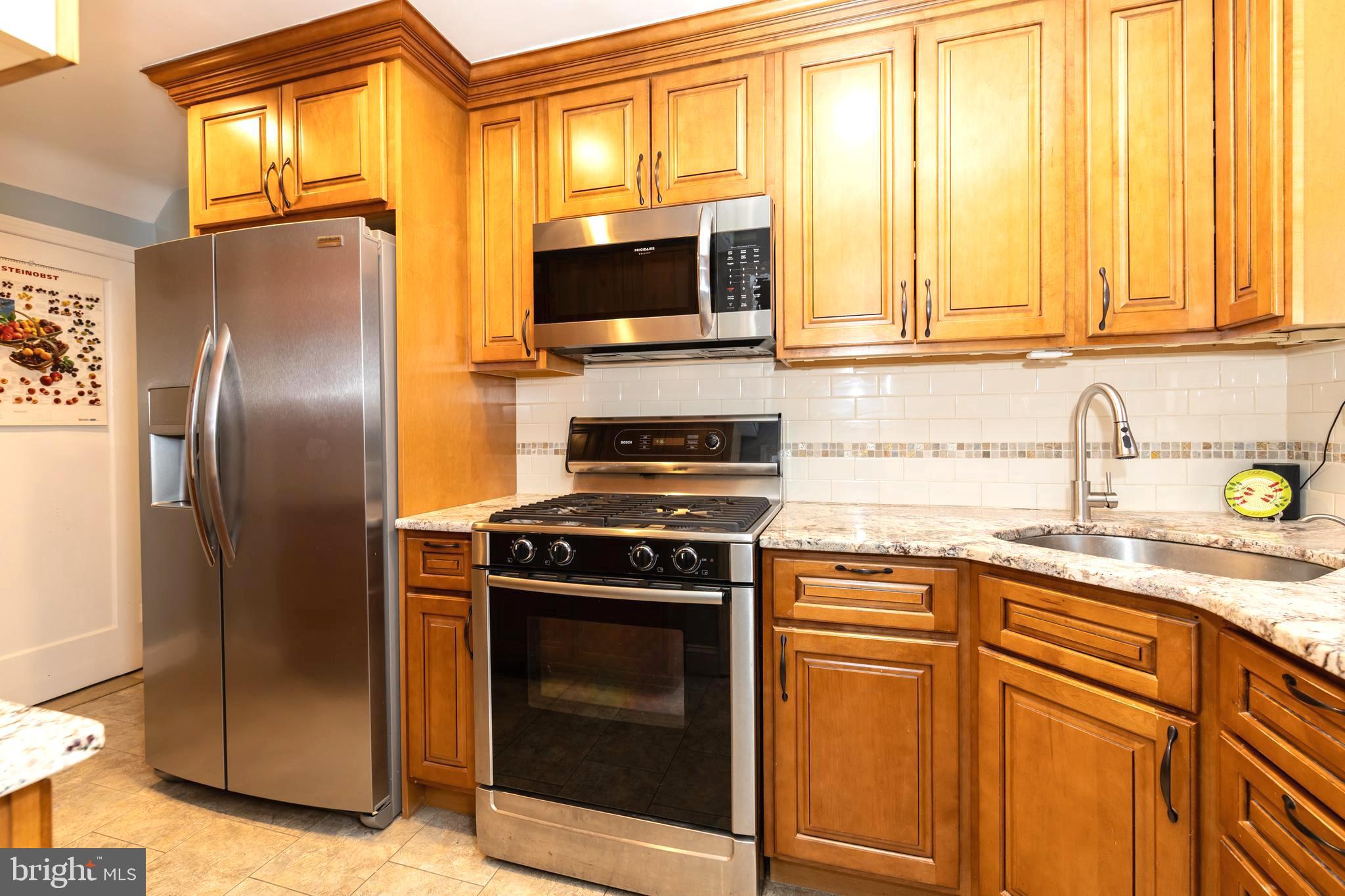 52 Woodbine Road Havertown, PA 19083 - Photo 15 of 38 a kitchen with stainless steel appliances granite countertop a stove a refrigerator and a sink