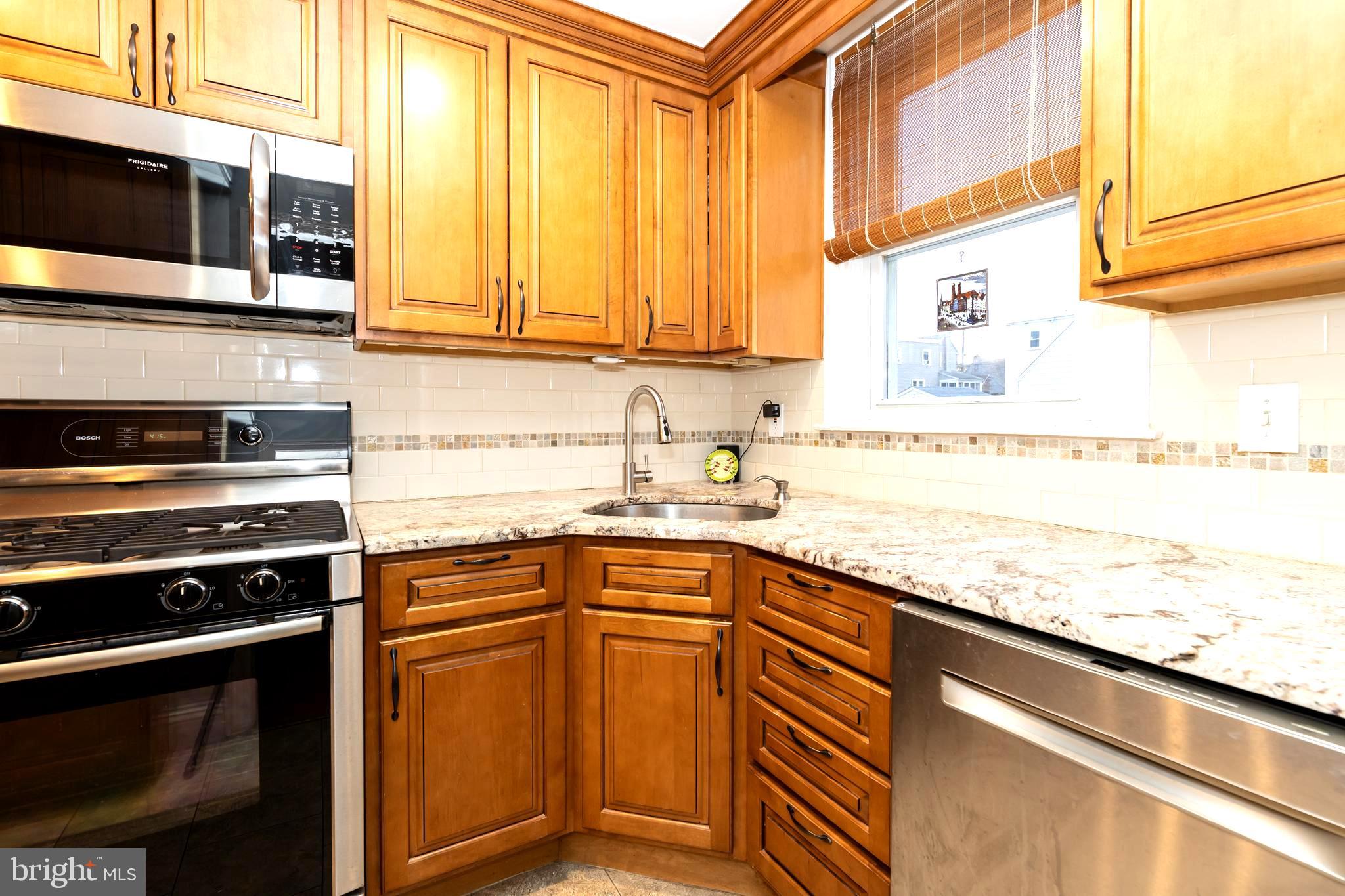 52 Woodbine Road Havertown, PA 19083 - Photo 17 of 38 a kitchen with stainless steel appliances granite countertop white cabinets and a stove top oven