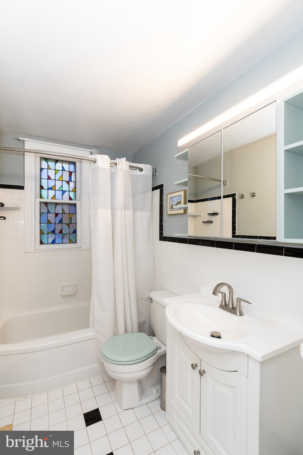 52 Woodbine Road Havertown, PA 19083 - Photo 28 of 38 a bathroom with a bathtub a sink a toilet and a mirror