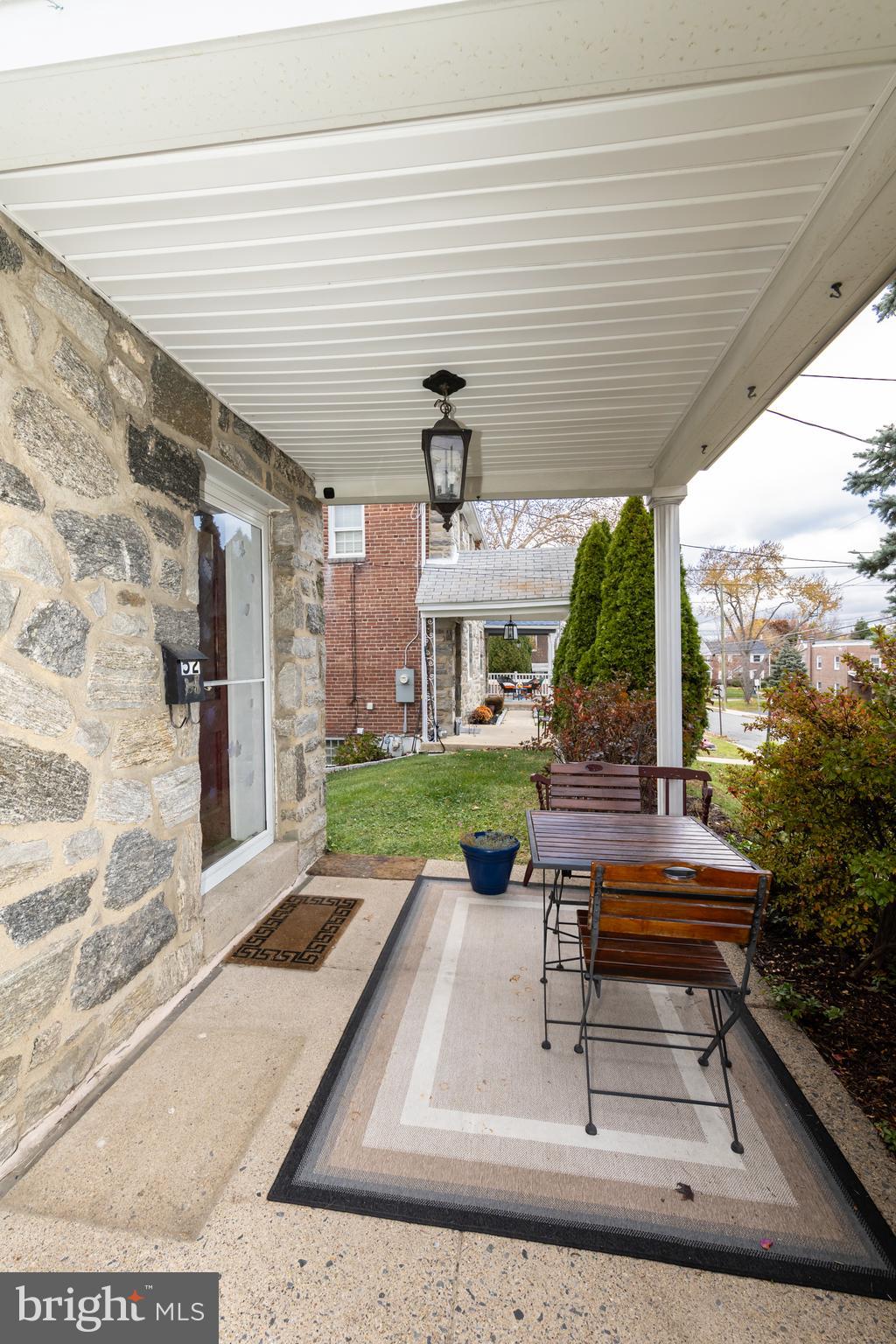 52 Woodbine Road Havertown, PA 19083 - Photo 3 of 38 a patio with table and chairs