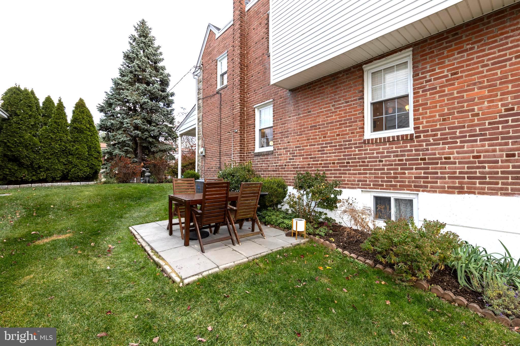 52 Woodbine Road Havertown, PA 19083 - Photo 34 of 38 a backyard of a house with table and chairs