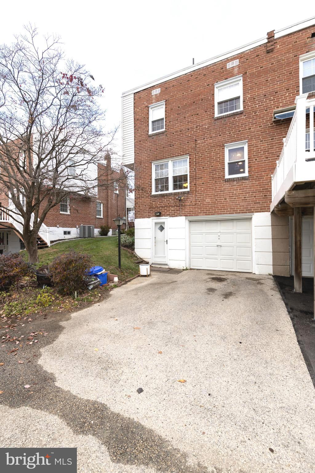 52 Woodbine Road Havertown, PA 19083 - Photo 38 of 38 a front view of a house with a yard and garage
