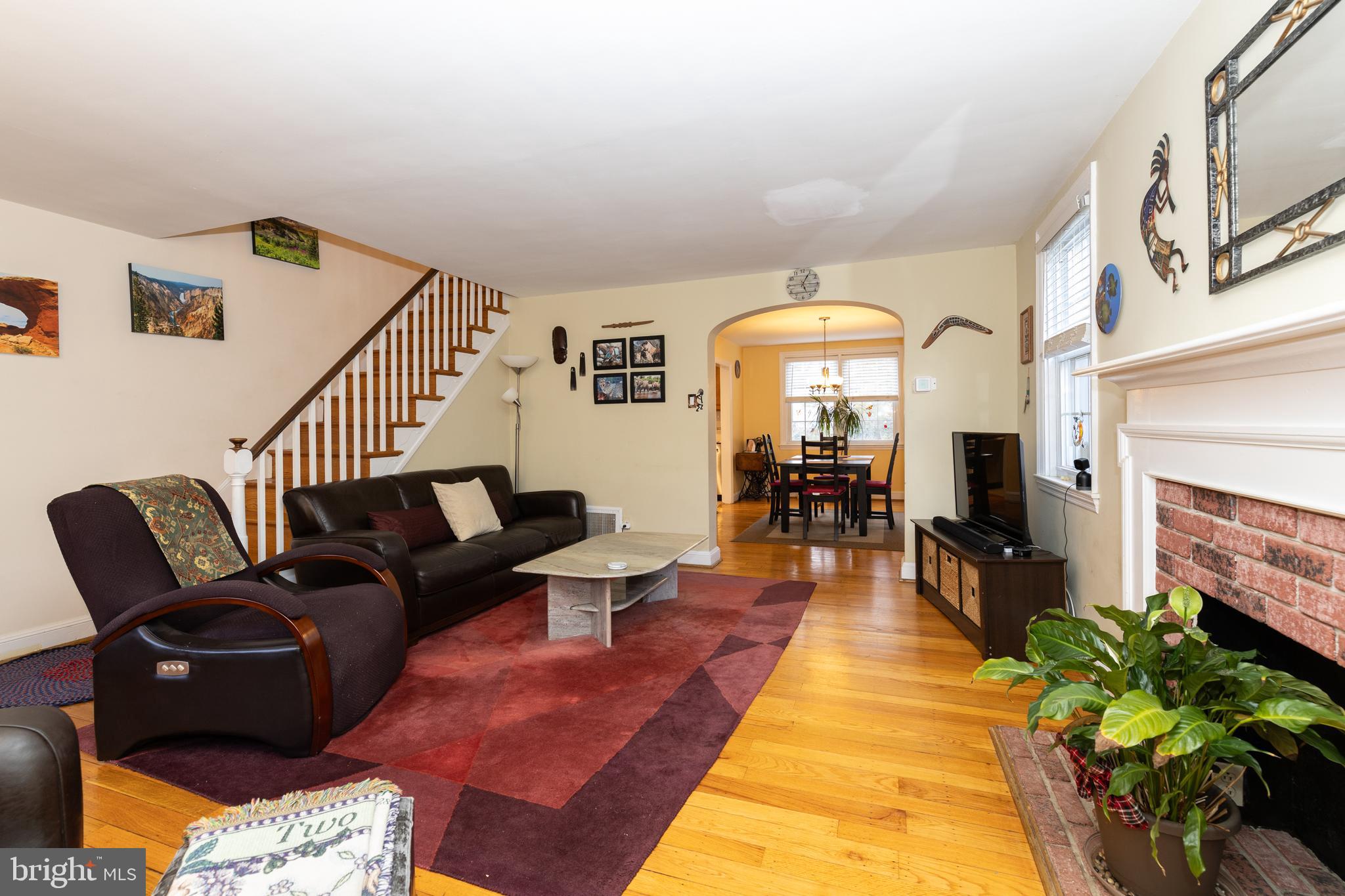 52 Woodbine Road Havertown, PA 19083 - Photo 7 of 38 a living room with fireplace furniture and a chandelier