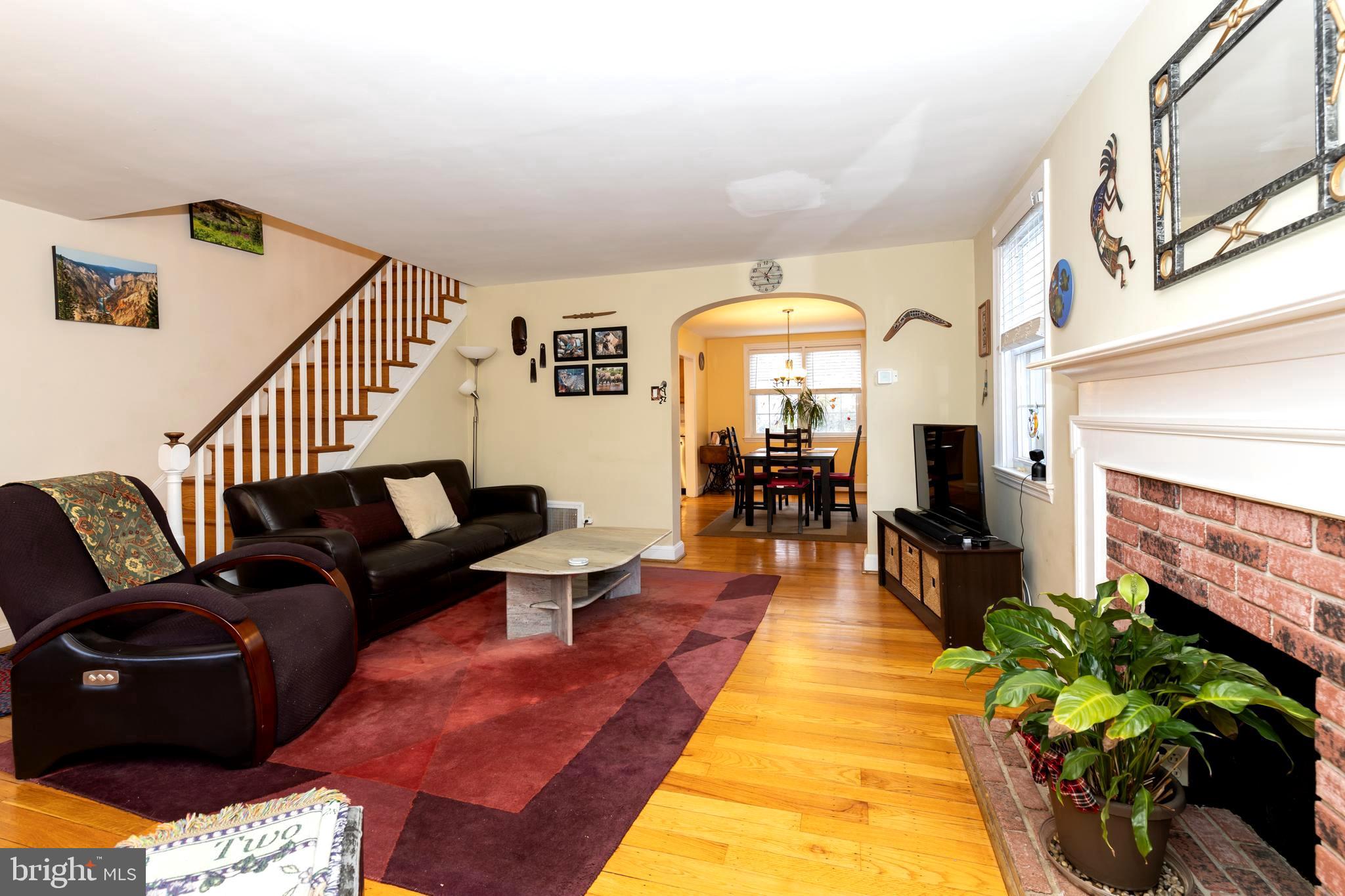 52 Woodbine Road Havertown, PA 19083 - Photo 10 of 38 a living room with fireplace furniture and a large window