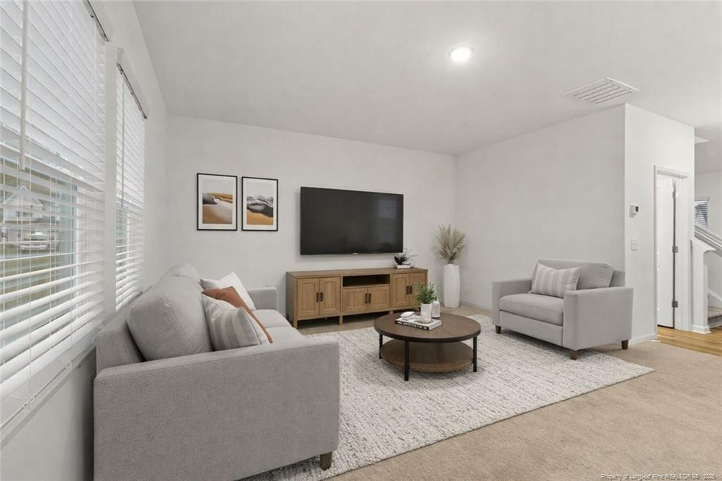 28 White Hart Court Angier, NC 27501 - Photo 15 of 36 a living room with furniture and a flat screen tv