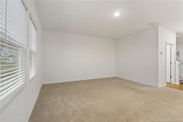 an empty room with a empty space and windows