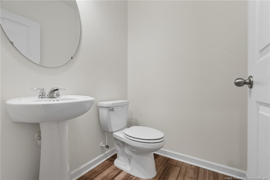 28 White Hart Court Angier, NC 27501 - Photo 17 of 36 a bathroom with a sink toilet and a mirror