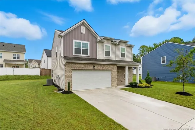 a front view of a house with a yard and garage
