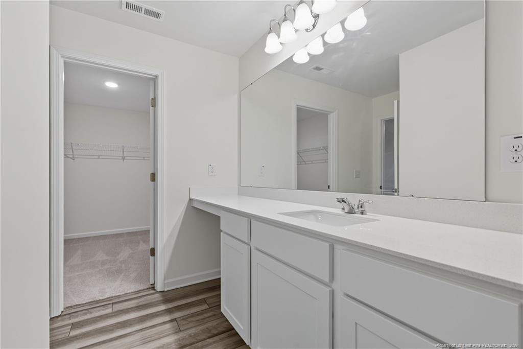 28 White Hart Court Angier, NC 27501 - Photo 23 of 36 a bathroom with a double vanity sink and a mirror