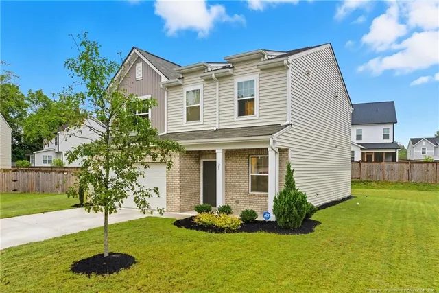 a front view of a house with a yard