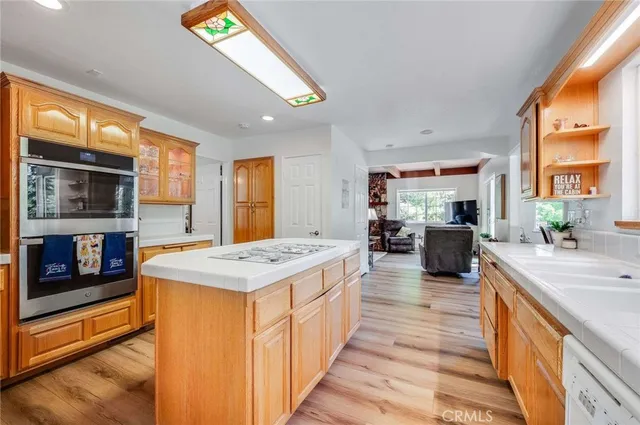 a kitchen with counter top space and wooden floor