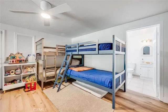 a bedroom with furniture and a wooden floor