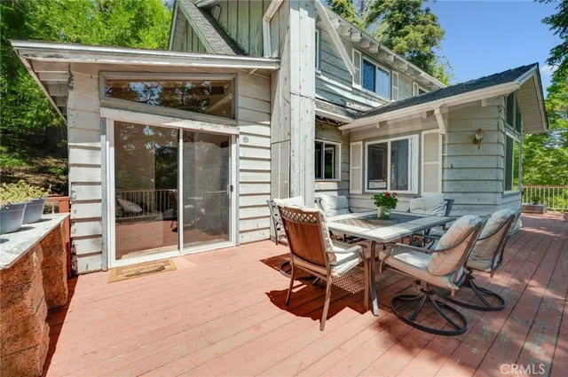 a view of a house with backyard and sitting area