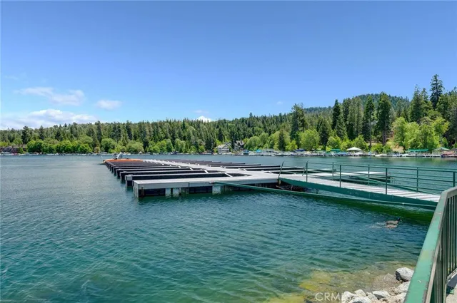 a view of yard with swimming pool and trees in the background