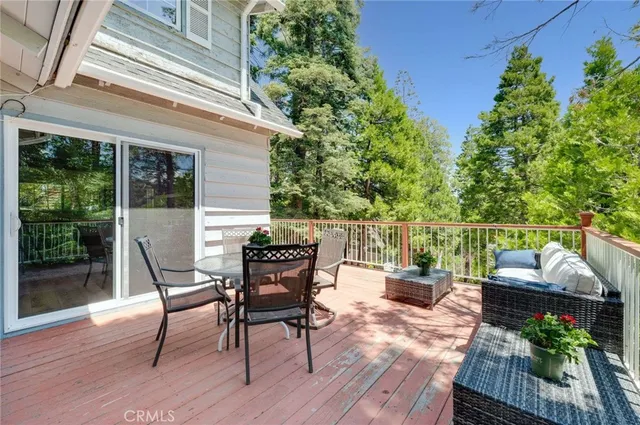 a outdoor view with a sitting space and large trees