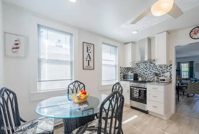 a view of a dining room with furniture and chandelier