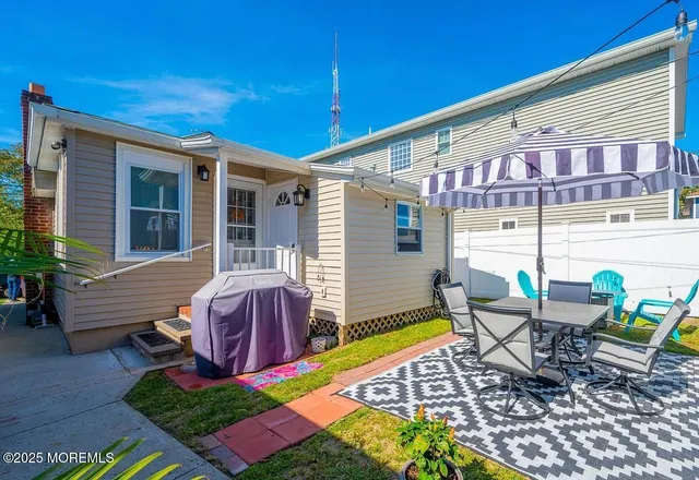 a view of a patio with table and chairs and potted plants