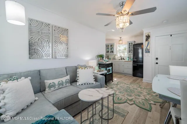 a living room with furniture a fireplace and a chandelier