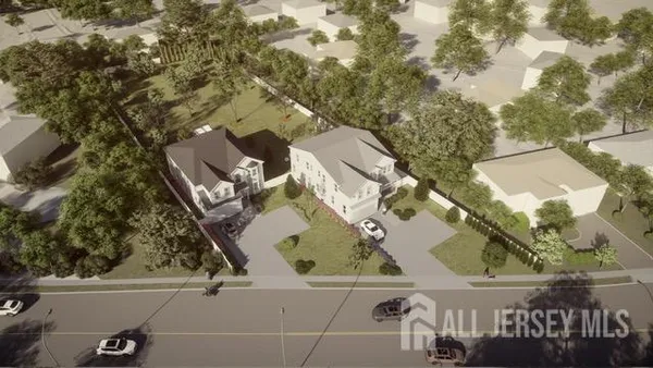 an aerial view of a house with a yard and parking spaces