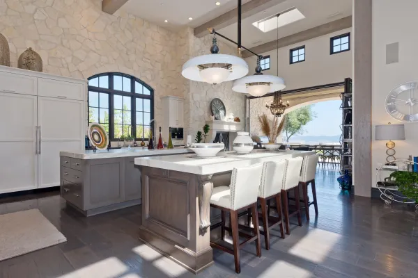 a large kitchen with a table and chairs