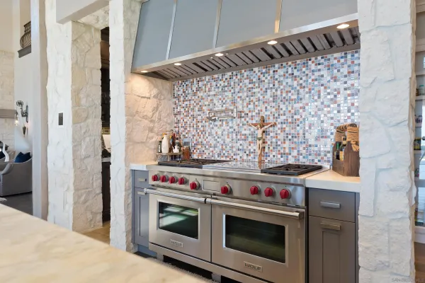 a stove top oven sitting inside of a kitchen