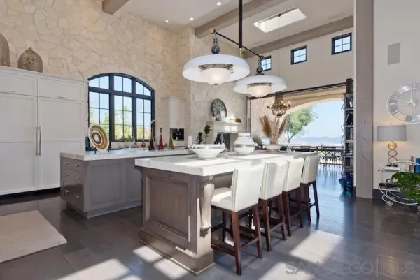 a large kitchen with a table and chairs