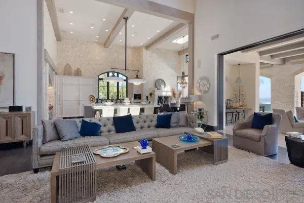a living room with furniture and a chandelier
