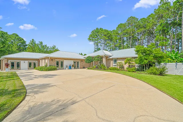 a kitchen with stainless steel appliances kitchen island granite countertop a table chairs and a refrigerator