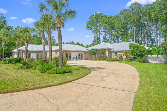 a living room with furniture large window and wooden floor