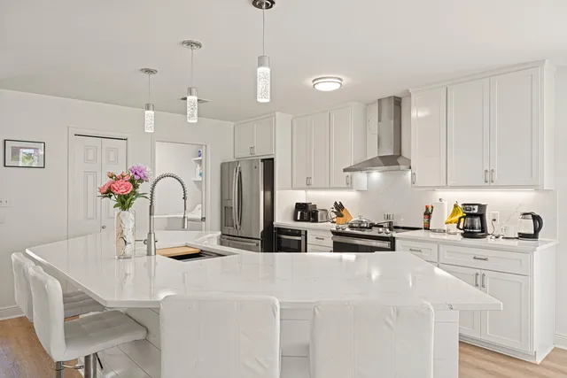 a bedroom with a bed and a mirror on the dresser